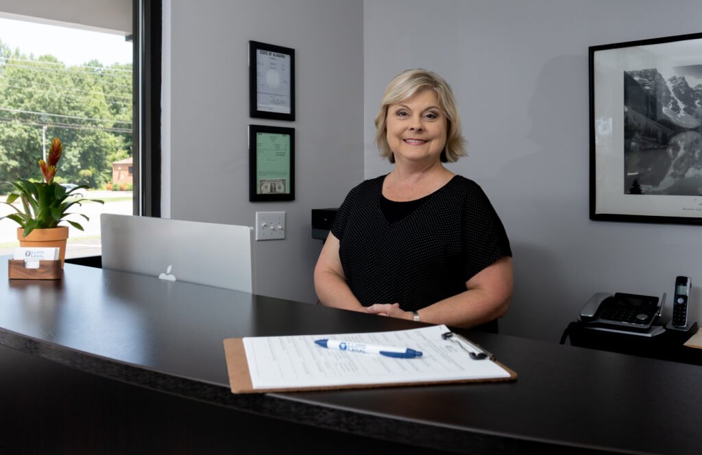 "Receptionist Lloyd Legal LLC, smiling warmly, reflecting approachability and expertise."